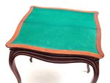 a small table with a green cloth on top of it
