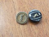 a small coin and a small coin sitting on a table