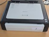 a printer sitting on a table next to a cell phone