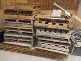 many pallets of wood stacked up in a room