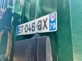 a suitcase sitting next to a street sign on the side of a building