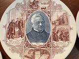 several plates with a picture of a man on them on a table