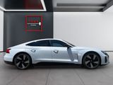 a white sports car parked in a garage next to a red sign