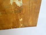 a picture of a piece of rusted wood with a picture of a man on it