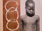 an old photo of a young boy with no shirt standing next to a painting of circles