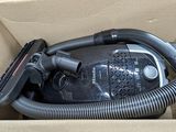 a box with a vacuum and a hose inside of it