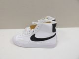 white and black nike blazer high top sneakers on a white surface