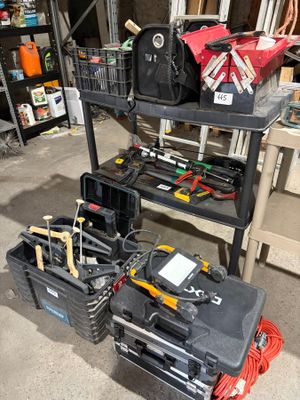 many tools on a shelf in a garage