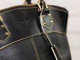 a black purse with a gold chain hanging from it ' s handle