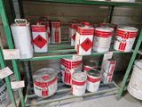 de nombreux pots de peinture sur une étagère dans un magasin