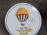 a plate with a hot air balloon painted on it
