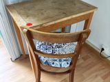 a small wooden table with a wooden chair next to it