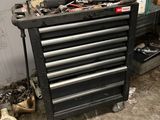 a black tool cabinet with tools on it in a garage