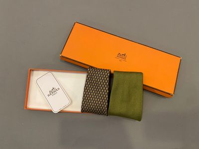 an orange box with a green tie and a brown and white tie
