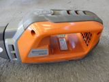 an orange and gray blower sitting on the floor