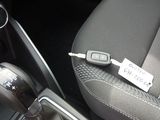 an image of a car interior with a car key in the center console