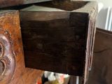 a wooden dresser with a drawer that has some paint on top of it
