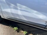 a car that has been dented and has been painted silver