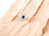 an image of a woman ' s hand with a diamond and sapphire ring