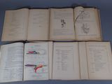 several open books on a blue surface with drawings on them