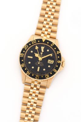 a close up of a wrist watch on a white surface