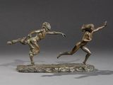 two bronze statues of a man and a woman on a rock