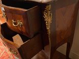 a wooden table with a marble top and two drawers