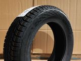 tire on the floor in front of a cardboard box with a cardboard box in the background