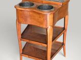 a small wooden table with two bowls on top of it