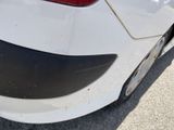a close up of a white car with a red tail light