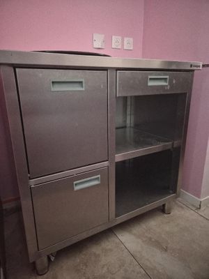 a stainless steel cabinet with two drawers and a door