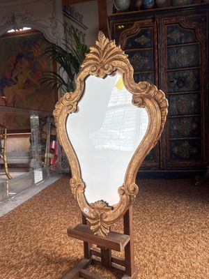 a mirror that is sitting on a stand in a room