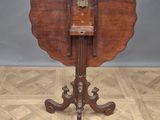 an old wooden table with a wooden top on a parquet floor