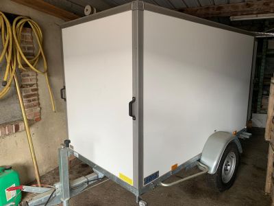 a trailer with a trailer attached to it in a garage