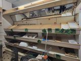 many empty shelves in a store with many items on them