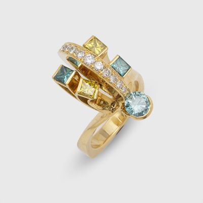 a close up of a gold ring with different colored stones