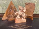 une statue représentant une femme à cheval, à côté d'une plaque représentant un homme