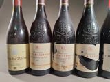 six bottles of wine are lined up in a row on a table