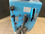 a blue machine that is sitting on a tiled floor