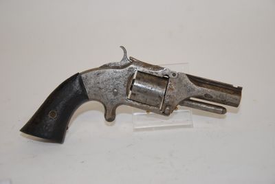 a gun that is on display on a white surface