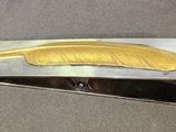 a silver and gold hair clip with a banana on it