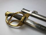 an image of a close up of a sword on a white surface