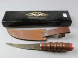 a knife that is sitting next to a box on a table
