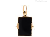 an image of a gold and black stone pendant on a white background