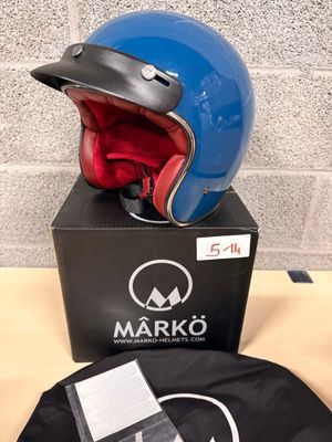 a blue helmet and a black bag on a table