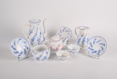 several pieces of blue and white porcelain are arranged on a white surface