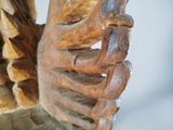 a close up of a wooden carving of a bird