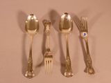 five silver spoons and a fork on a table