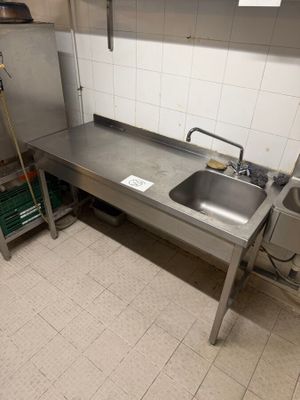 a kitchen with a sink and a stove in it