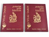 two red books with gold foil on them sitting on a white surface